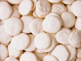 Box of fresh meringues close up background photo