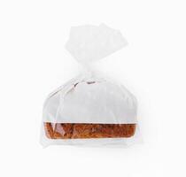 Loaf of wheat bread in plastic bag isolated photo