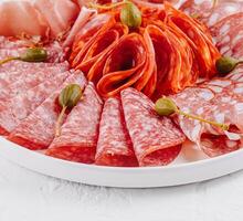 Assorted deli meat platter on white background photo