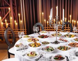 Elegant dinner table setup with candlelight photo