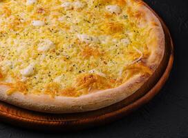 Fresh baked cheese pizza on wooden board photo