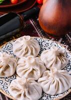 Georgian dumplings khinkali on traditional plate photo