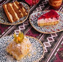 Traditional desserts on patterned tablecloth photo