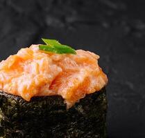 Gourmet salmon tartare sushi on black slate photo