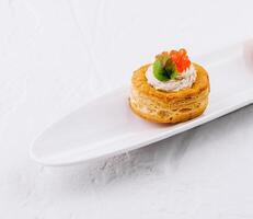 Gourmet vol-au-vent appetizers with salmon caviar photo