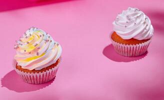Festive cupcakes on pink background photo
