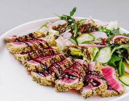 Gourmet sesame-crusted tuna salad on plate photo