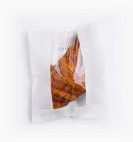 Sealed bag of loose croissant isolated on white photo