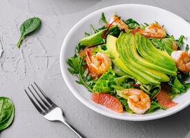 Fresh shrimp avocado salad on gray tabletop photo