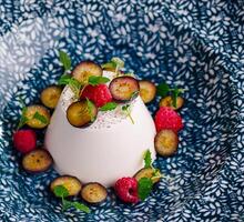 Elegant vanilla panna cotta with fresh berries photo