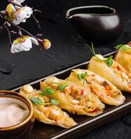 Gourmet dumplings with dipping sauce on elegant tableware photo