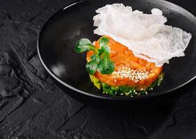 Gourmet salmon tartare with avocado and crisp photo