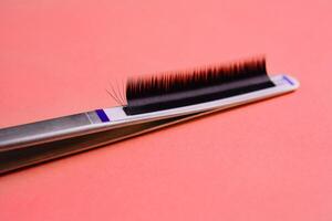 Close-up of false eyelashes on red background photo