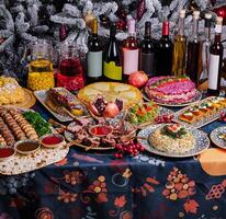 Festive holiday feast with decorated christmas tree photo