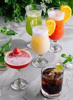 Variety of refreshing cocktails on rustic table photo