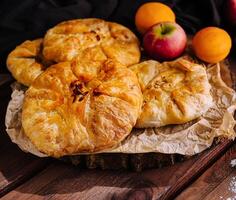 Homemade fruit galettes on rustic table photo