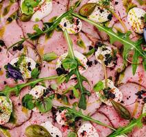 Gourmet roast beef carpaccio with fresh herbs photo