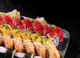 Assorted sushi platter on black background photo