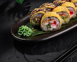 Delectable sushi rolls plated on dark slate background photo