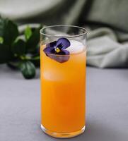 Elegant cocktail with edible flower garnish photo