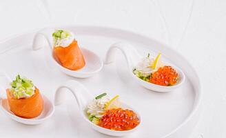 Elegant appetizers on white platter photo