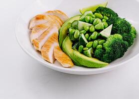 Healthy grilled chicken and green vegetables plate photo