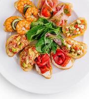 Gourmet bruschetta platter on white background photo