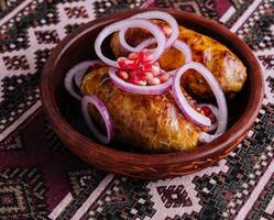 Traditional georgian dish shkmeruli in ceramic bowl photo