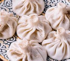 Georgian dumplings khinkali on traditional plate photo