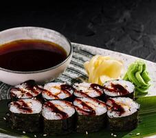 Elegant sushi rolls on slate background photo