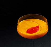 Elegant cocktail with citrus garnish on dark backdrop photo