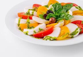 Fresh caprese salad with pesto sauce photo