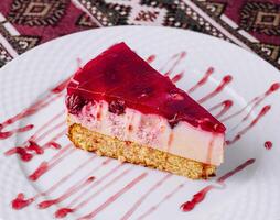 Delicious raspberry cheesecake slice on plate photo