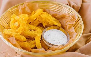 Crunchy breaded shrimp with dipping sauce and chips photo