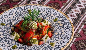 Traditional caprese salad on ornate plate photo