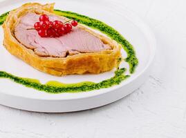 Gourmet pork tenderloin with redcurrant and pesto photo