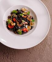 Gourmet seafood pasta with squid ink spaghetti photo