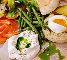 Gourmet breakfast platter with poached eggs and salmon photo