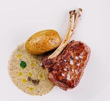 Gourmet lamb chop with roasted potatoes photo