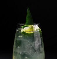 Refreshing lime cocktail on dark background photo