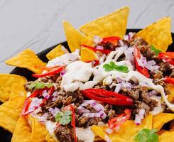 Loaded nachos on cast iron skillet photo