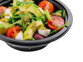 Fresh avocado salad in a black bowl photo