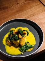 Gourmet fish filet with clams and spinach photo