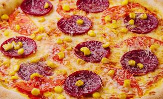 Appetizing pepperoni pizza close up photo