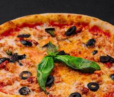 Fresh italian pizza with basil and olives photo