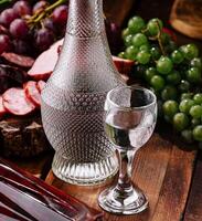 Elegant display glass of vodka on wooden table photo