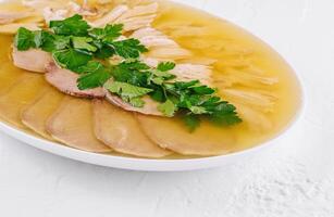 Traditional chicken aspic with parsley garnish photo