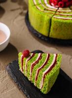 Green tea matcha cake with fresh raspberries photo