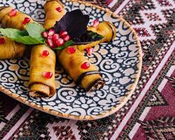 Traditional stuffed grape leaves on ornate plate photo