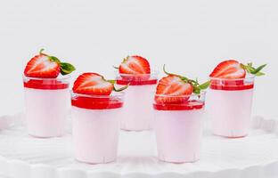 Fresh strawberry panna cotta on elegant white stand photo